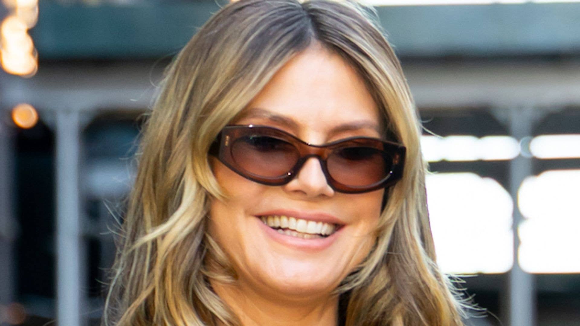 Heidi Klum flaunts cleavage in plunging mini dress as she takes puppy for a walk