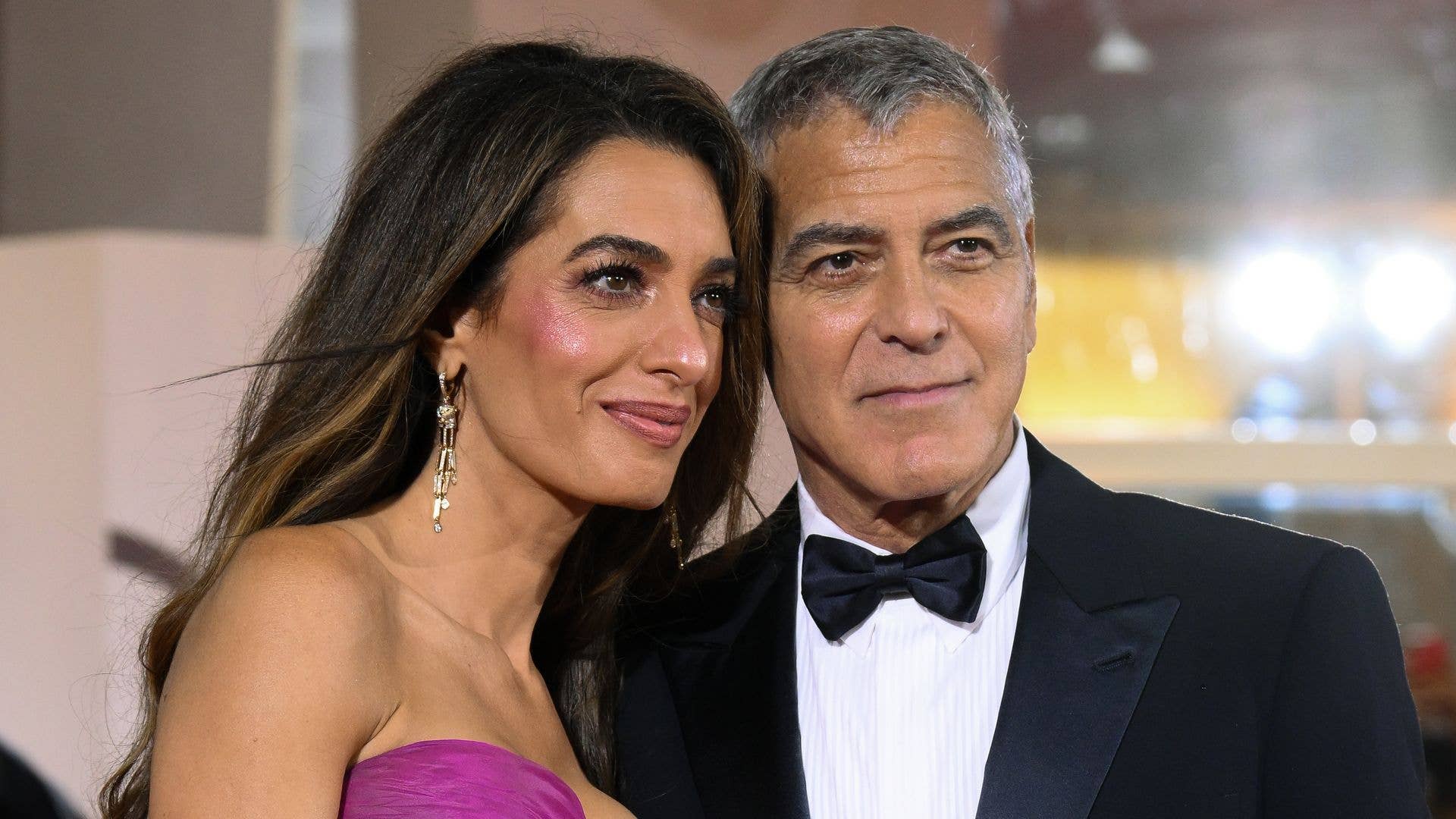 George and Amal Clooney look so in love as they pack on the PDA amid milestone birthday celebration